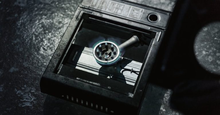 Close-up of a gas stove burner with a blue flame, indicating energy consumption.