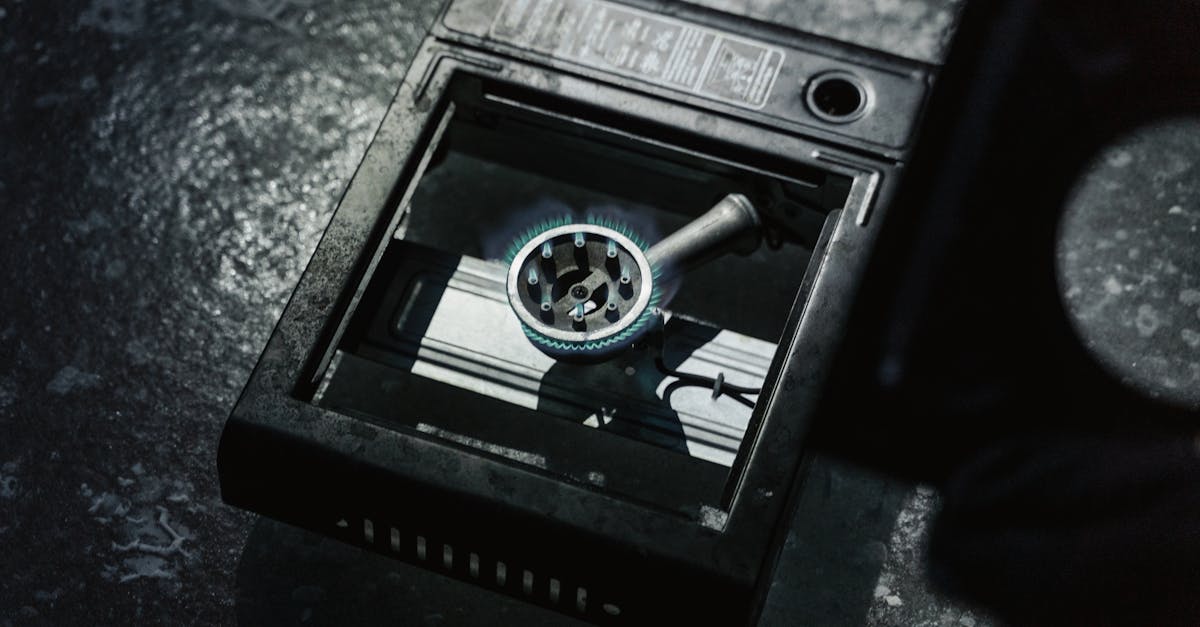 Close-up of a gas stove burner with a blue flame, indicating energy consumption.