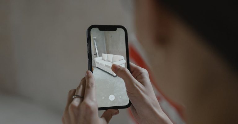A person holding a smartphone, using augmented reality to view and capture a virtual overlay of a modern sofa inside a room.